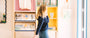 Girl in Buen Dia coffee shop, walking with a cup of coffee and a navy blue sweatshirt