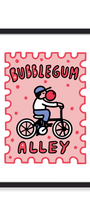 Framed art print featuring a pink stamp-like design with the words “BUBBLEGUM ALLEY” and a cartoon child riding a bicycle with a red bubble gum ball, shown in a black frame against a white background.