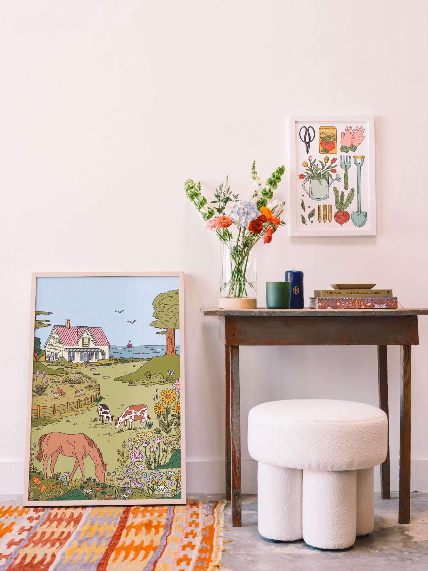 Gallery wall styled with Buen Dia Gardening Tools print and Seaside Cottage print above a vintage console table